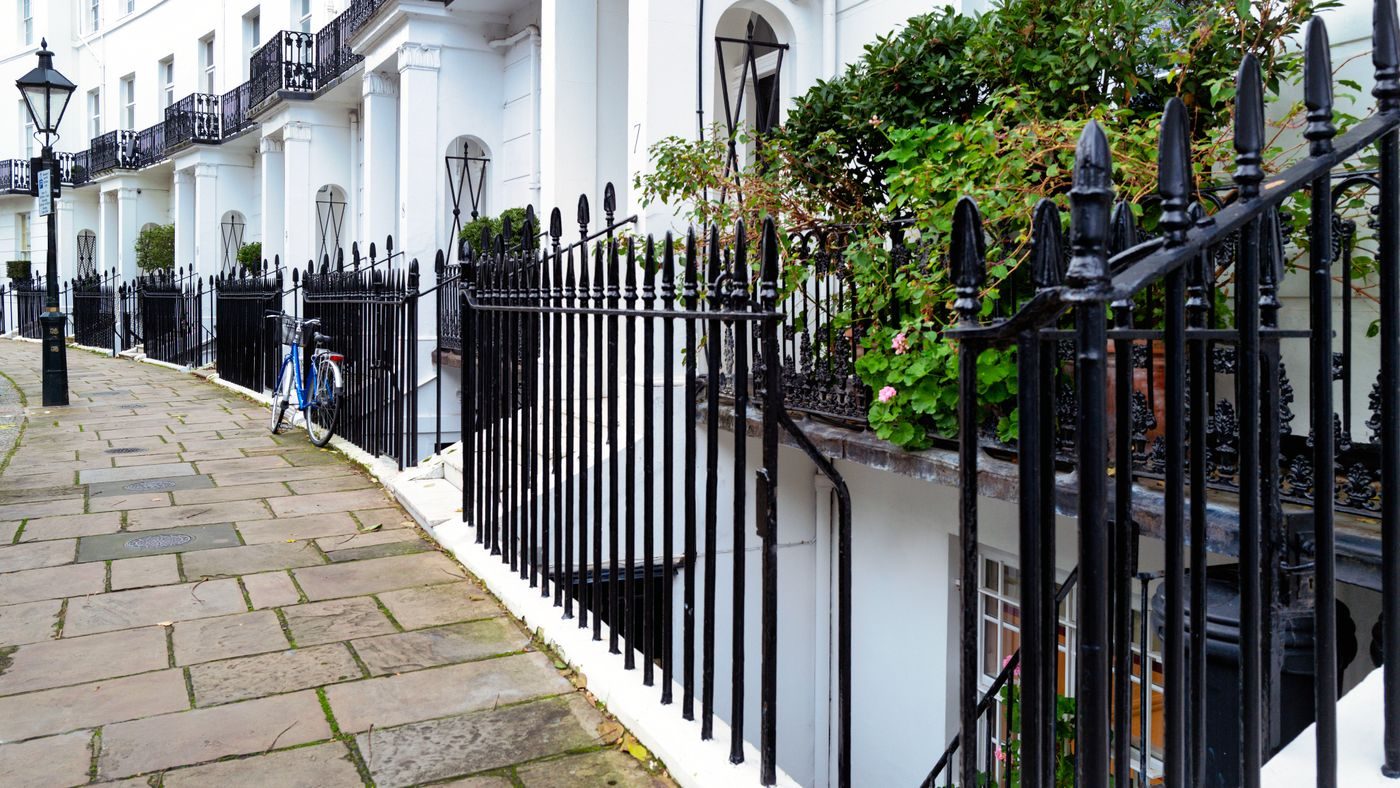 White stucco Georgian terrace with black railings in Kensington, West London